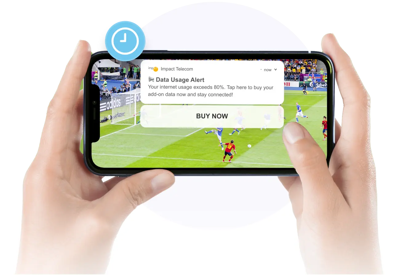Hands hold a smartphone horizontally, displaying a full-screen soccer match. A time-sensitive notification overlays the video, warning: "Data Usage Alert! Your internet usage exceeds 80%. Tap here to buy your add-on data now and stay connected!" with a "BUY NOW" button.