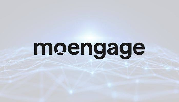 MoEngage logo in black lowercase lettering over a light background with a subtle digital network pattern.